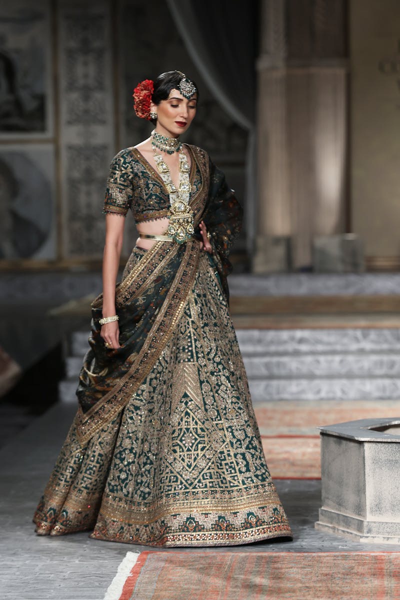 Stunning Indian bridal fashion with an intricately designed lehenga at a fashion show.