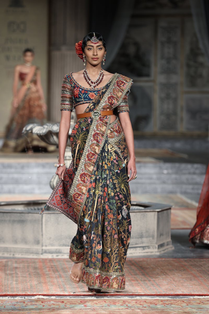 A fashion model in traditional attire on the runway in New Delhi, India.